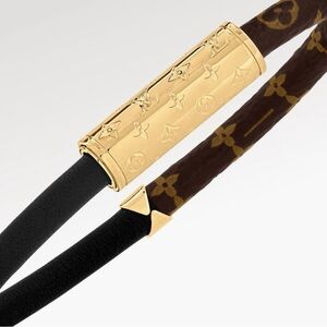Authentic Louis Vuitton monogram with black leather bracelet.